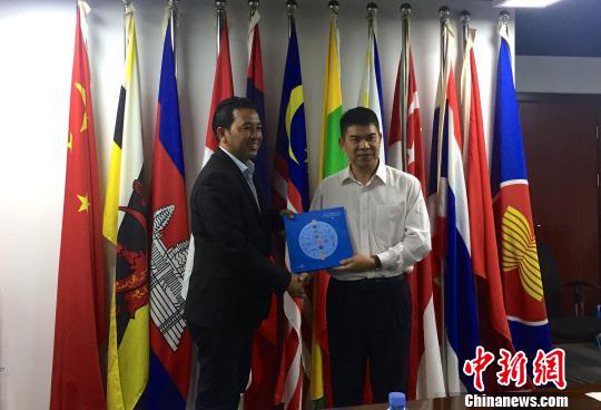 中國(guó)—東盟博覽會(huì)秘書處副秘書長(zhǎng)黃平西（右）與柬埔寨新聞部新聞與傳播總司副總司長(zhǎng)春占皮侖（左）互贈(zèng)禮物。